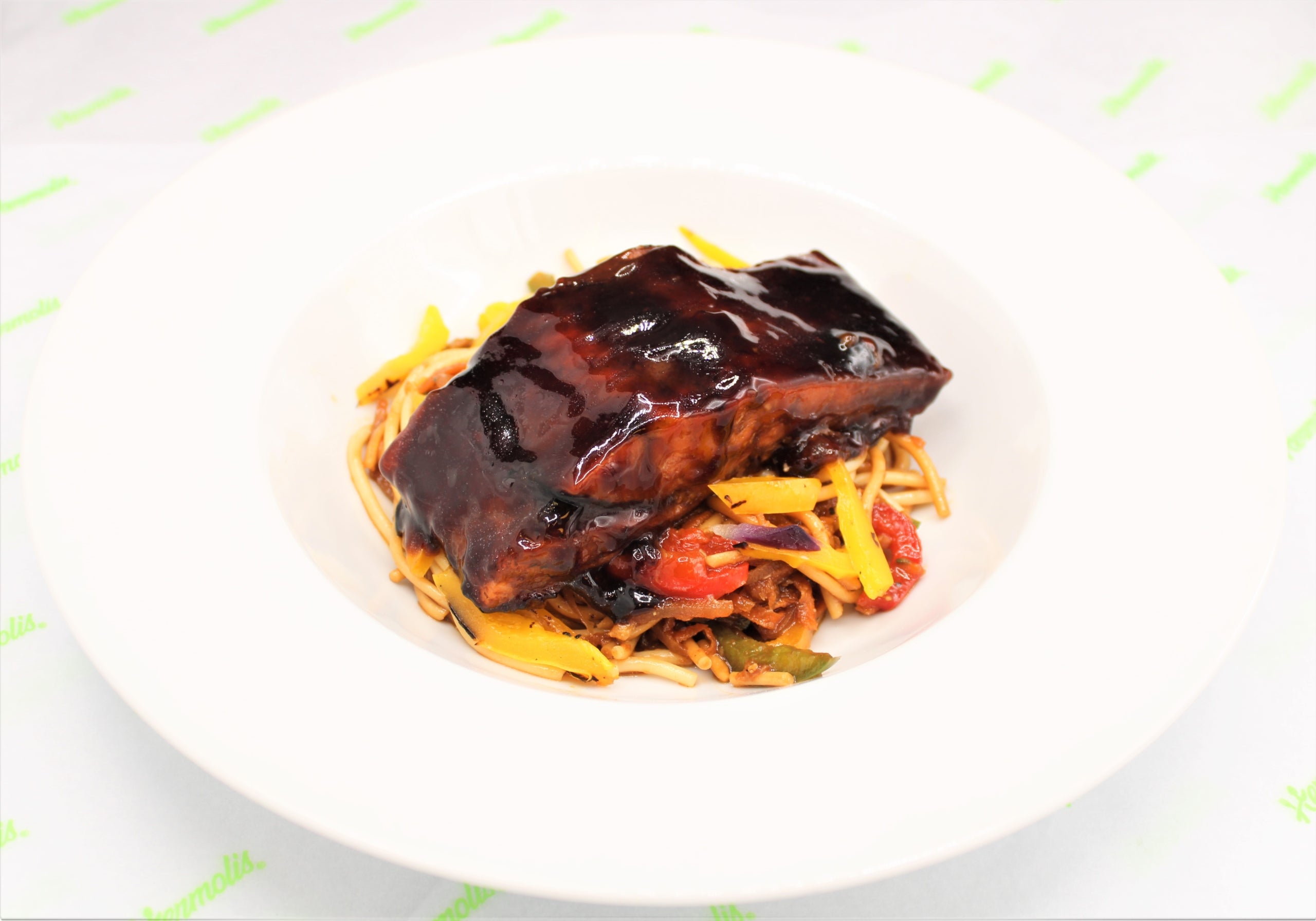 Teriyaki Salmon served on a bed of Oriental Noodles with Mango Tapenade in ramekin